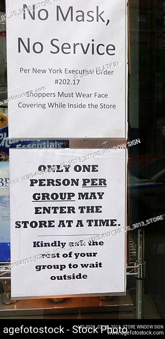 Sign in store window regarding face masks and social distancing guidelines